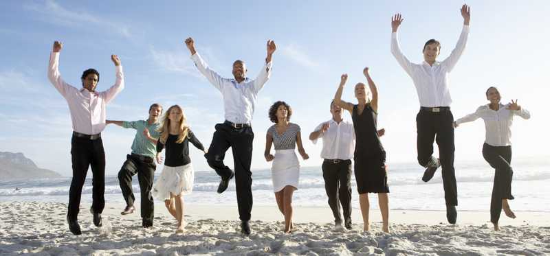 People on a beach cheering.