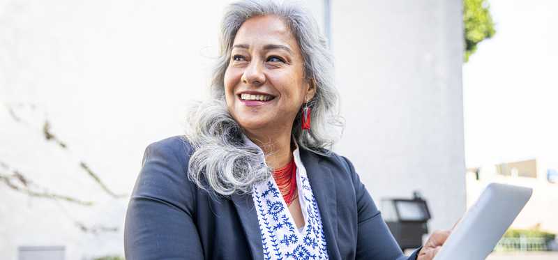 Person smiles while at the office.