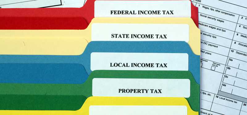 A series of labeled tax folders in various colors.