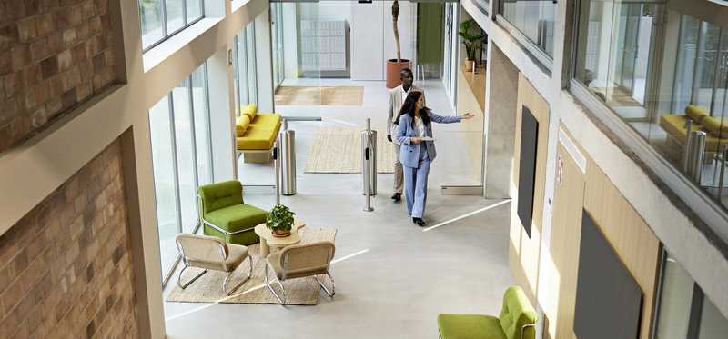 A real estate agent showing office real estate to someone.