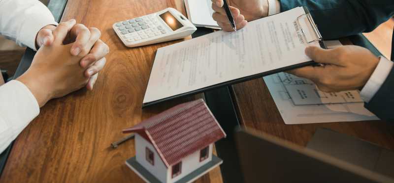 Person signing a pad handed to them by another person.