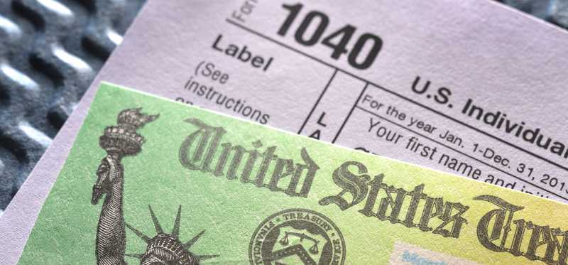 A 1040 form and tax refund check.