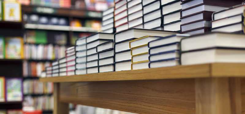 A table of books on display in a bookstore.