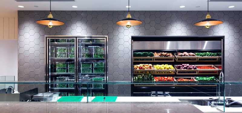 The inside of a Sweetgreen showing display cases of fresh produce.