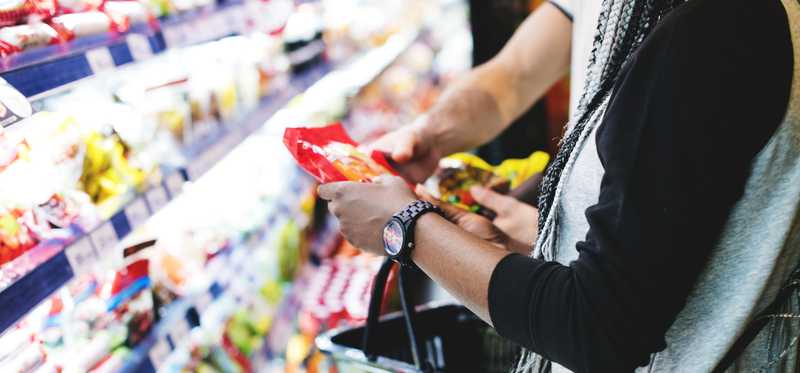 Shoppers pick up items at a grocery store.