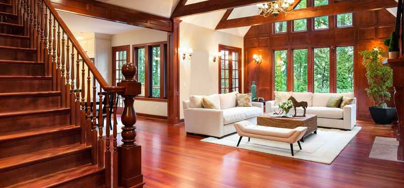 A home interior with rich wood and large windows.