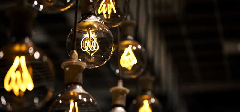 Hanging lightbulbs that are lit up.