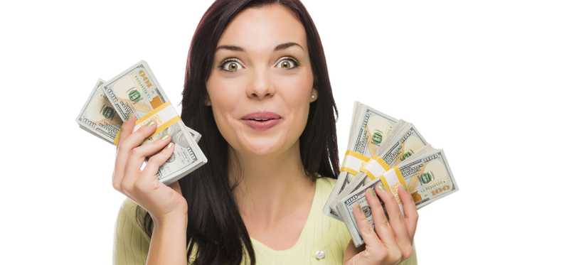 A person excitedly holding up cash in each hand.