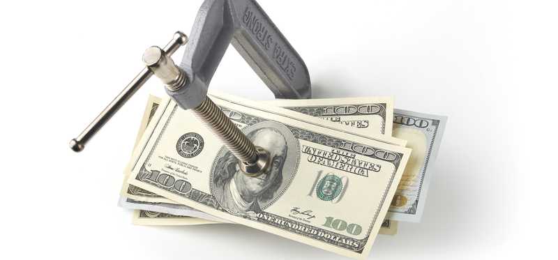 Vise gripping hundred dollar bills