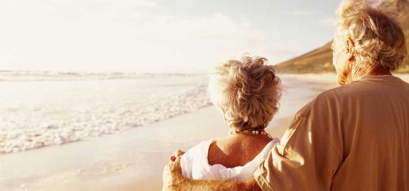 A couple walking on the beach.