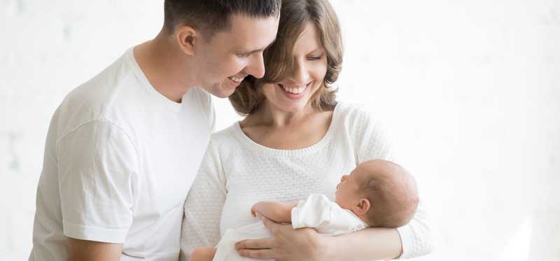 Parents holding an infant.