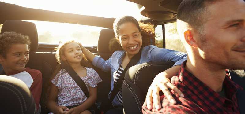 Young family in a vehicle with the top down.
