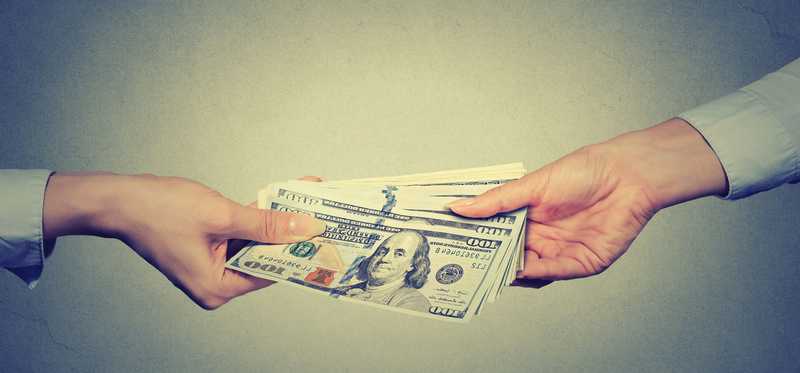A pile of bills exchanges hands.