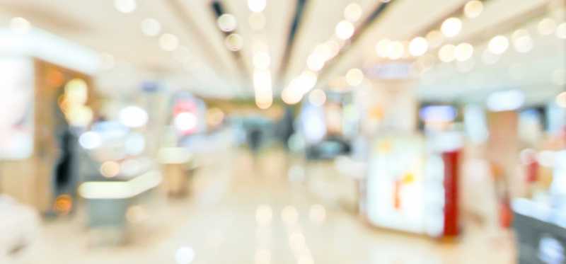 A somewhat blurry photo of the inside of a well lit department store.