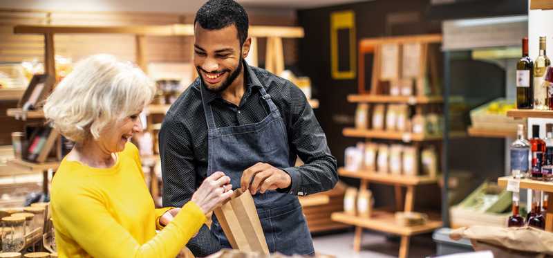 Worker assisting customer in shop.
