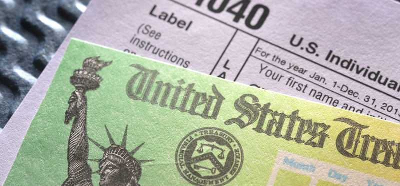 Tax refund check and 1040 form.
