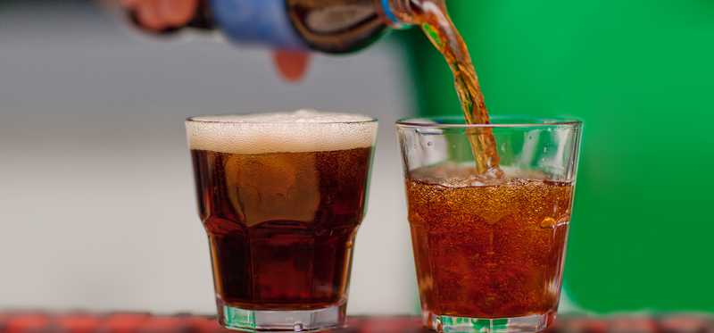Soda being poured into glasses.