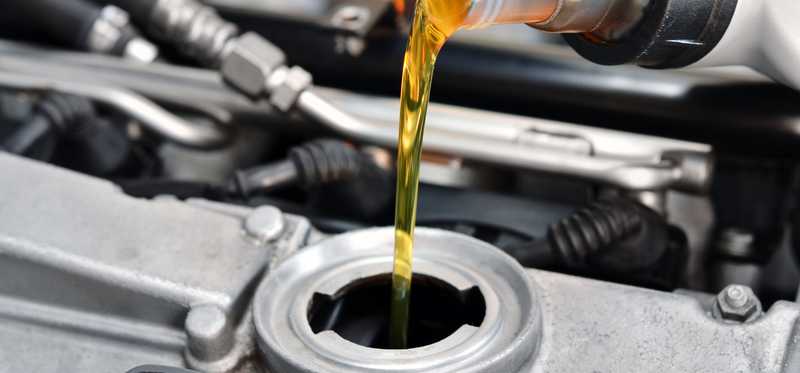 Fluid being added to a car's engine.