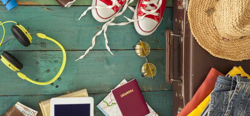 Various travel-related items from a suitcase spilled out.