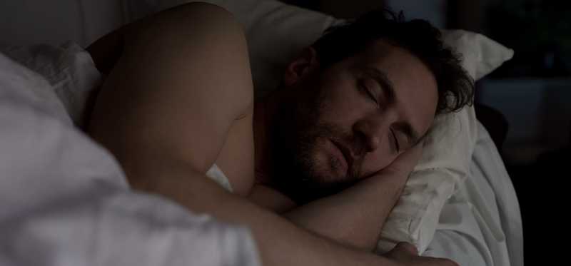 Person sleeping in bed.