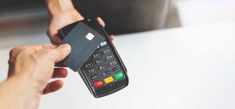Credit card being used on a point of sale terminal.