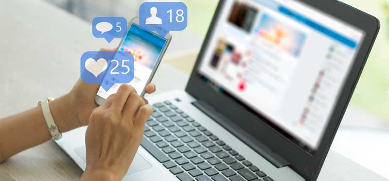 Person holding smartphone and using social media.