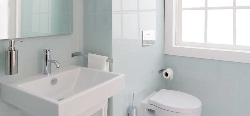 A bathroom painted in a light blue shade.