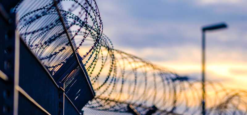 Barbed wire atop prison wall
