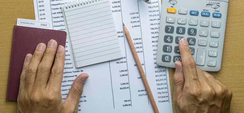 Paperwork, notepad, pen, and calculator.
