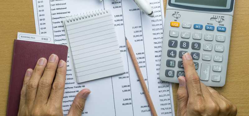 Paperwork, notepad, pen, and calculator.