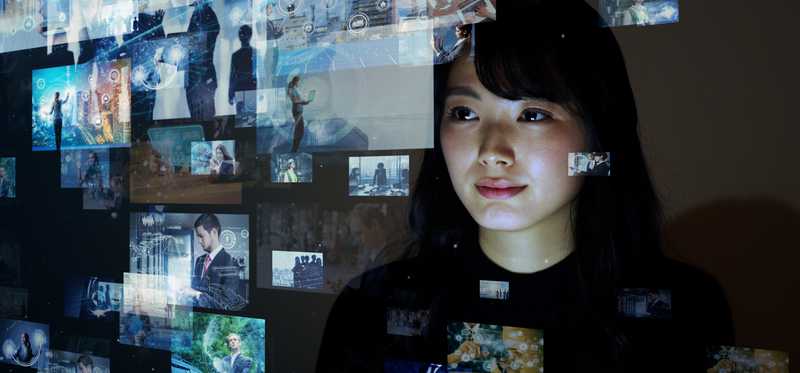 Person looking at several different projected images.