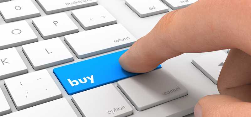 Finger pressing buy button on keyboard