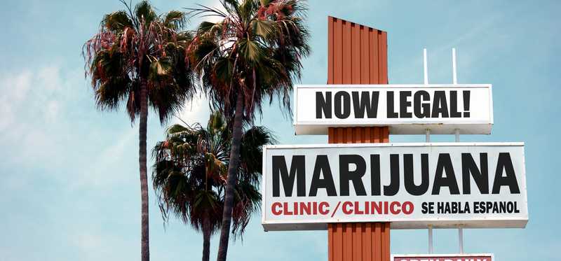 A large road sign with the words Now Legal Marijuana