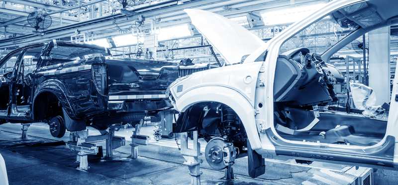 An auto assembly line with vehicles in process.