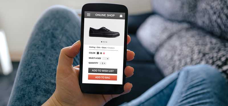 Person shopping for shoes on a smartphone.