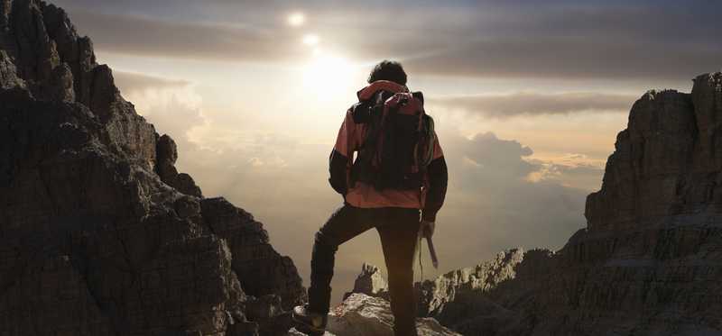 Mountain climber looks out to the distance.