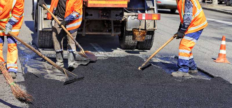 Road construction crew paving street