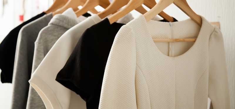 A rack of simple, plain colored clothing.