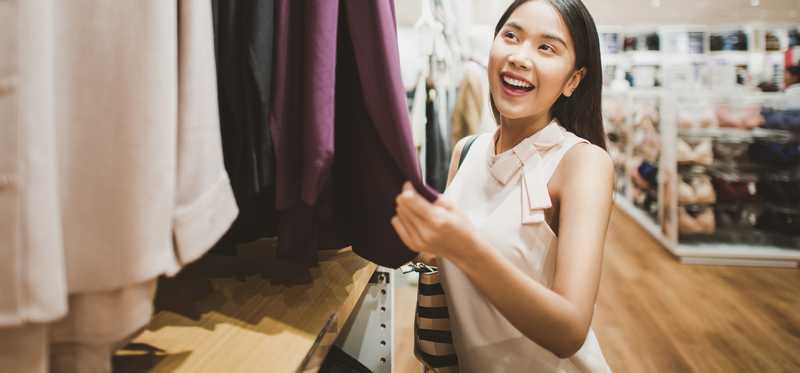 Person shopping in a clothing store.