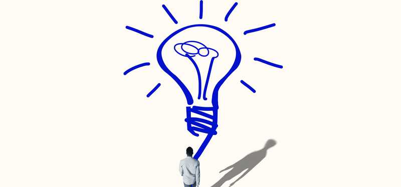 Man following a drawn trail to a light bulb