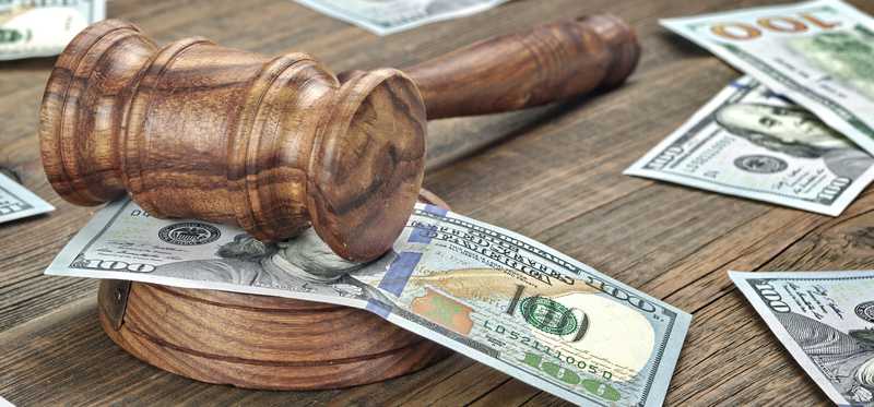 Gavel and hundred dollar bills.