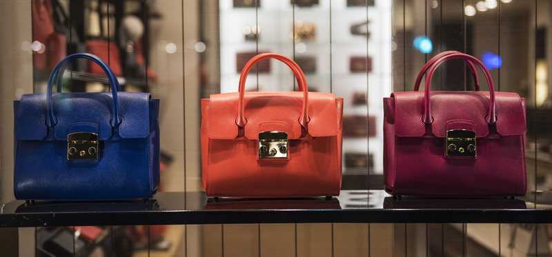 Brightly colored handbags on display.
