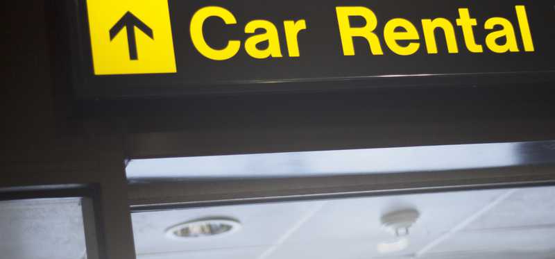 A sign pointing in the direction of Car Rental.