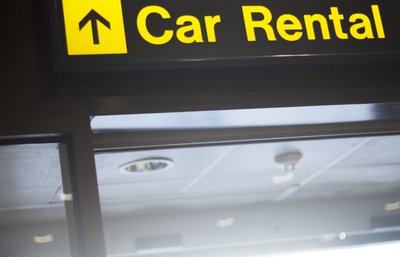 A sign pointing in the direction of Car Rental.
