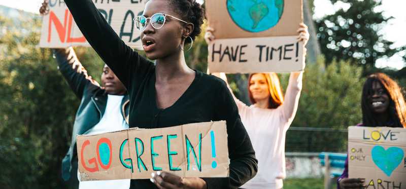 Protesters demonstrating for green energy and environmental causes.