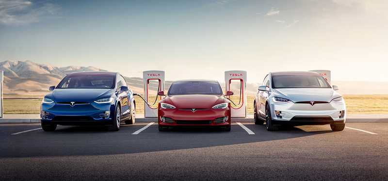 A Tesla supercharger with 3 vehicles charging