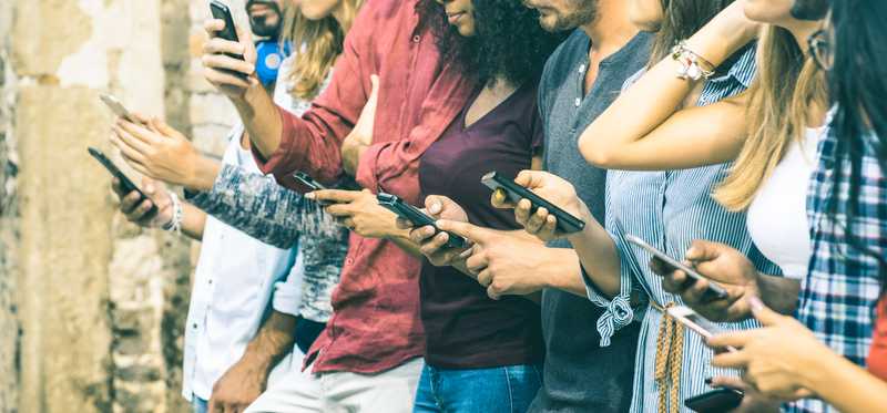 A group of people on their phones.