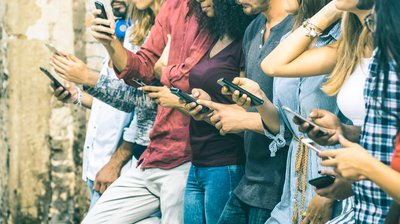 A group of people on their phones.