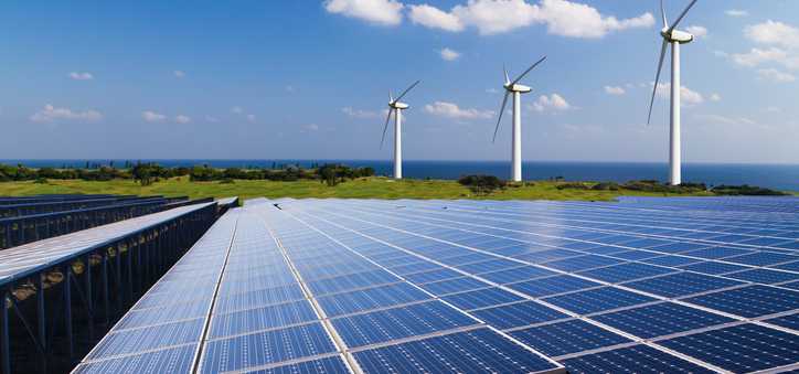 Solar panels and wind turbines in a field.