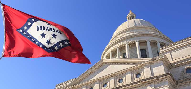 The Arkansas capitol and state flag.